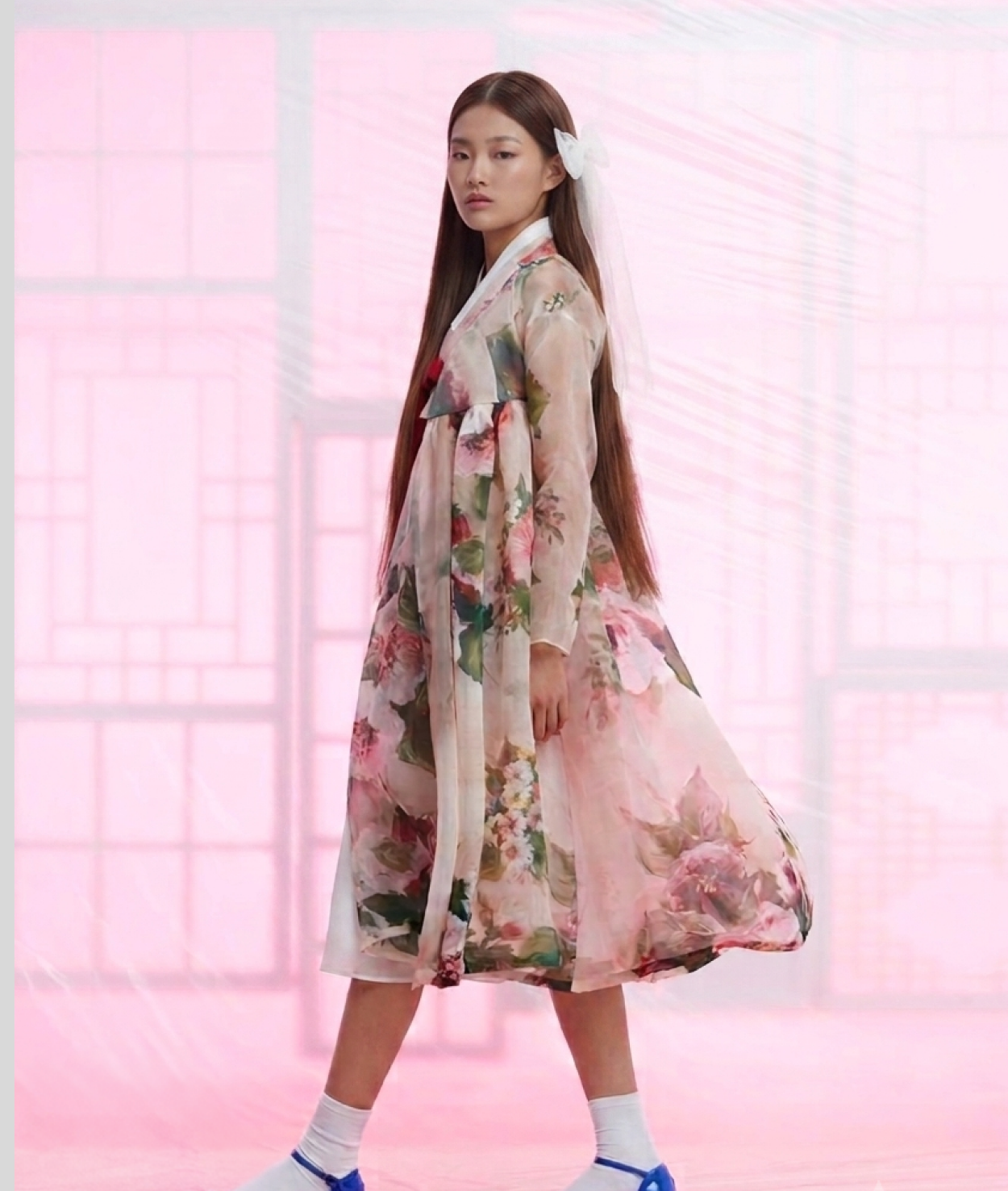 2019 collection — a floral organza dress in front of a pink lattice screen
