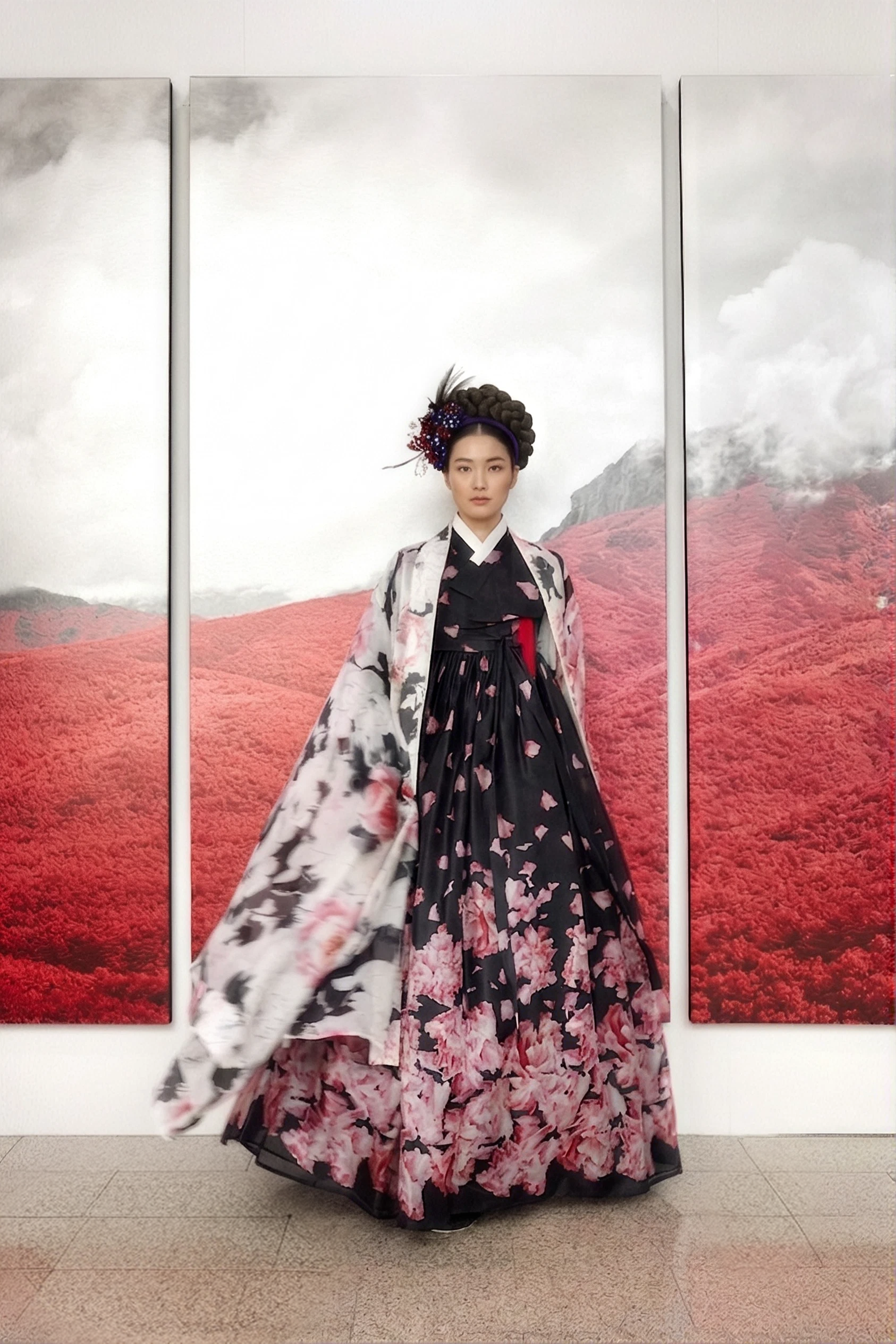 2021 collection — a black floral gown in front of a triptych of red mountain landscapes