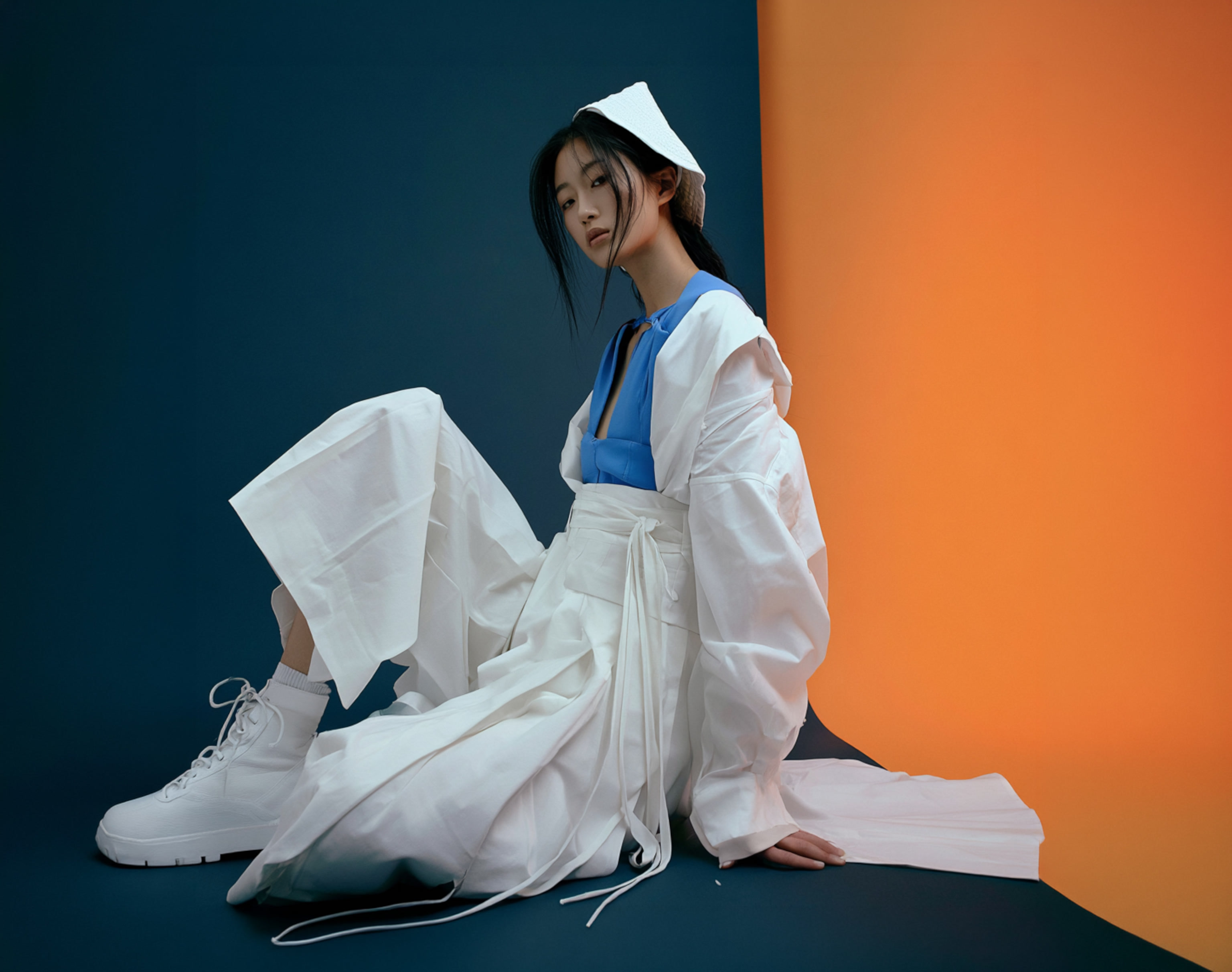 A model wearing an everyday modern hanbok in soft daylight
