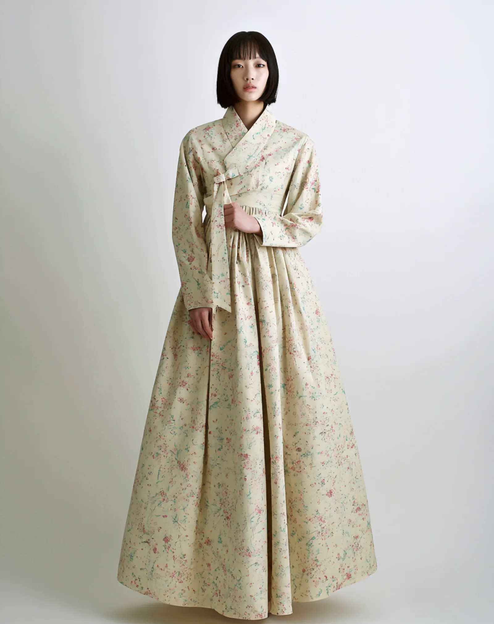 A model wearing the Flower Hill Cheollik Dress, a cropped hanbok jacket in 80-count cotton