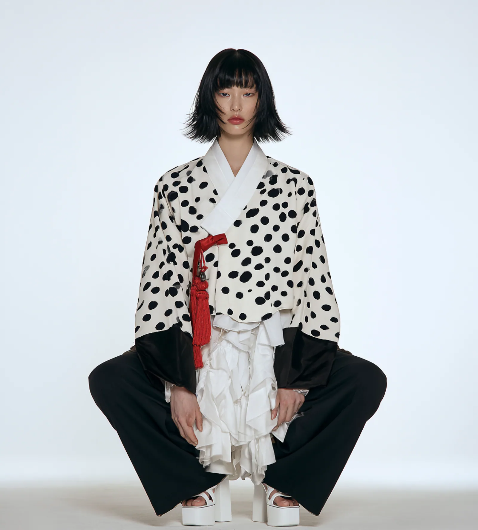 A model wearing the Dot Jeoksam Jeogori, an oversized puff-sleeve jeogori in a bubble dot print