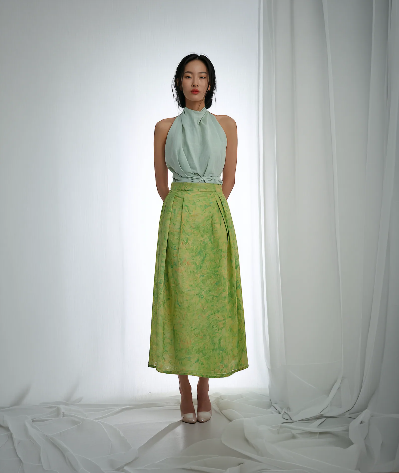 A model wearing the Geodeul Floral Chima, a layered wrap skirt in lightweight linen